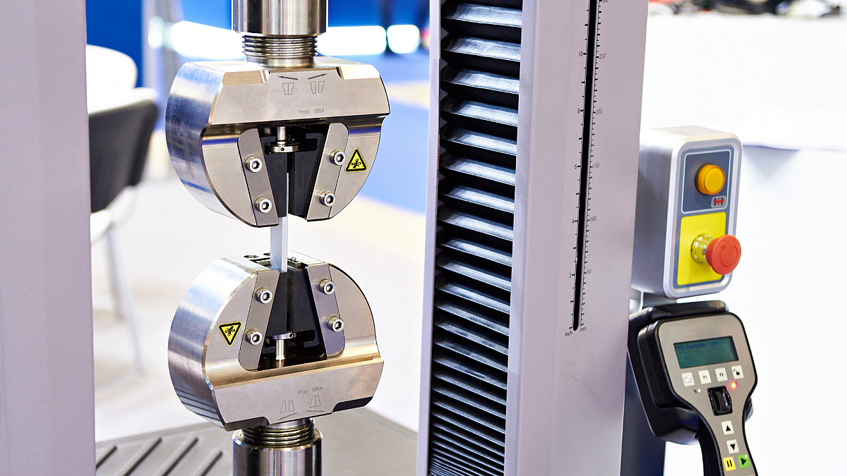 tensile testing machine testing the strength of a steel sample