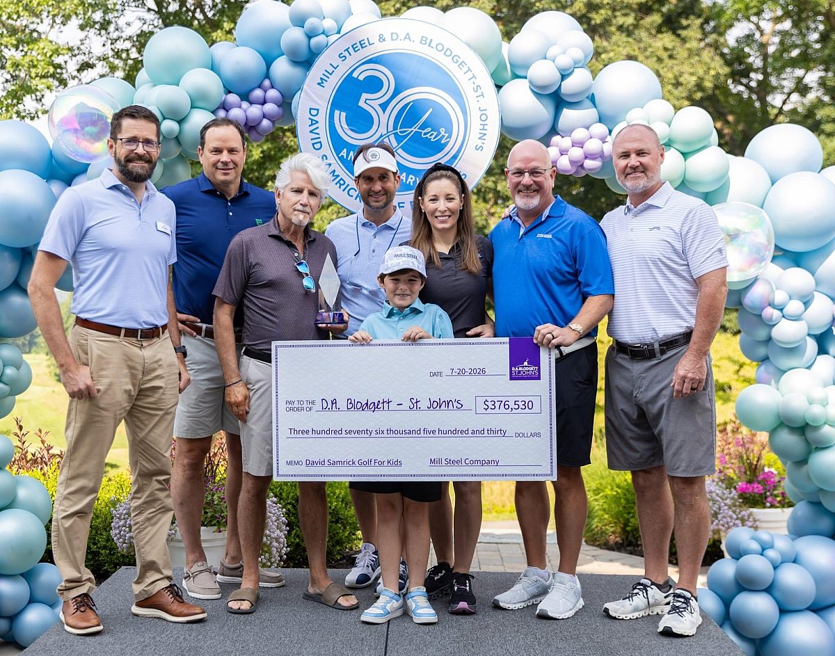 Picture of executive team holding up the $376,530 check.