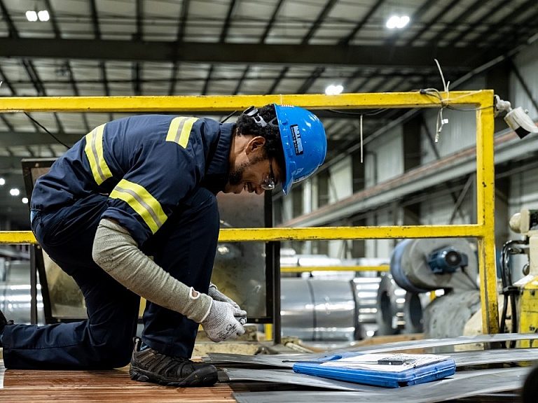Mill Steel technician measuring a slitted coil for quality testing